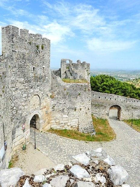 Berat Castle stone walls and towers with scenic hillside view in Albania.