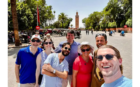 Group of tourists in front of Koutoubia Mosque during private Marrakech city tour.