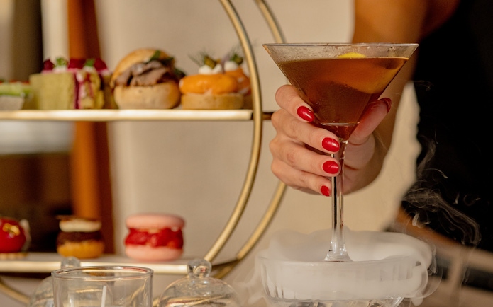 Afternoon tea with pastries and cocktail at The Samovar Lounge, Dubai.