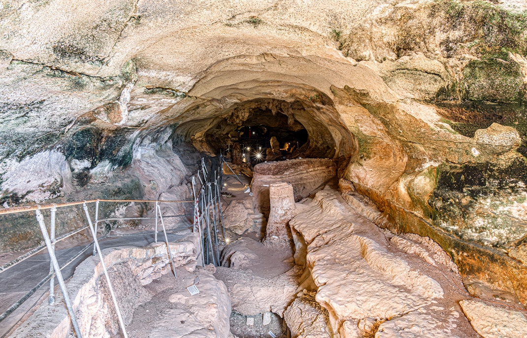 Ghar Dalam caves entrance with stone pathway in Malta.