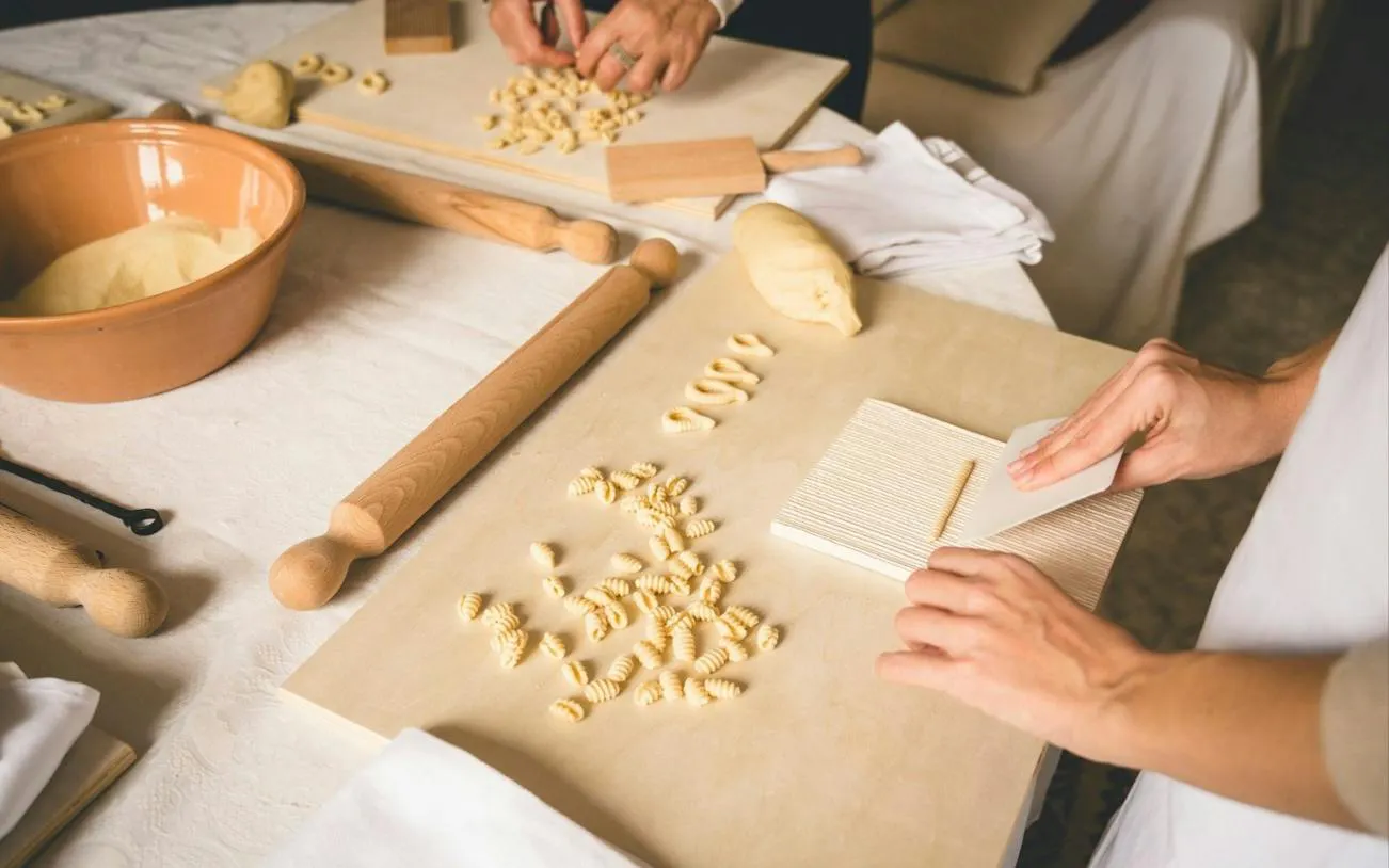 Traditional Sardinian pasta being shaped by hand in a Cagliari workshop.