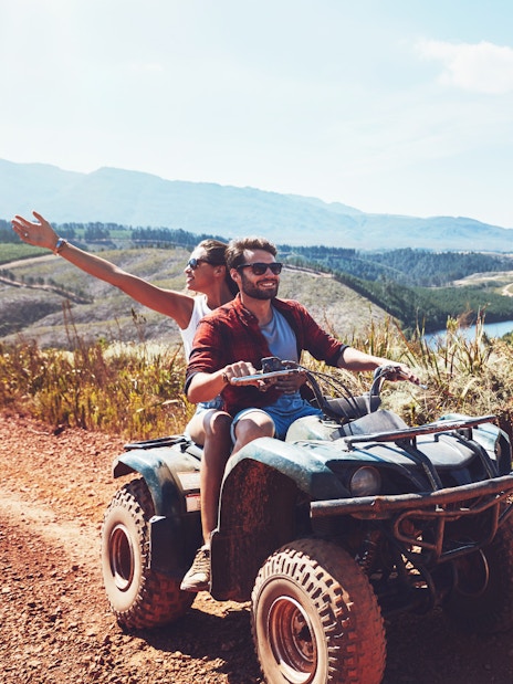 Couple riding quad bike on dirt trail during safari in Antalya.