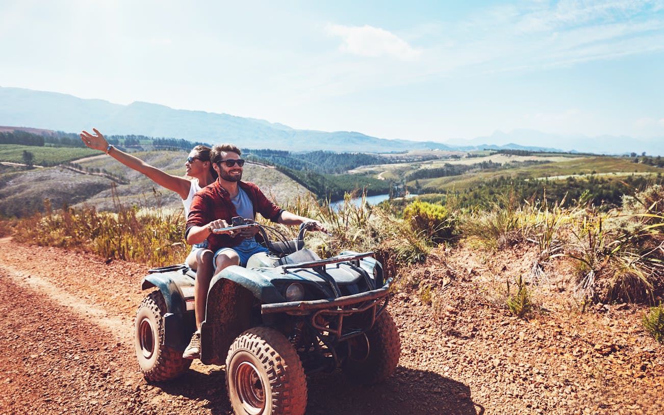 Couple riding quad bike on dirt trail during safari in Antalya.