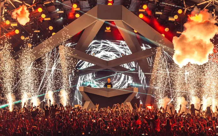 DJ performing at Ushuaïa Ibiza with vibrant lights and fireworks.