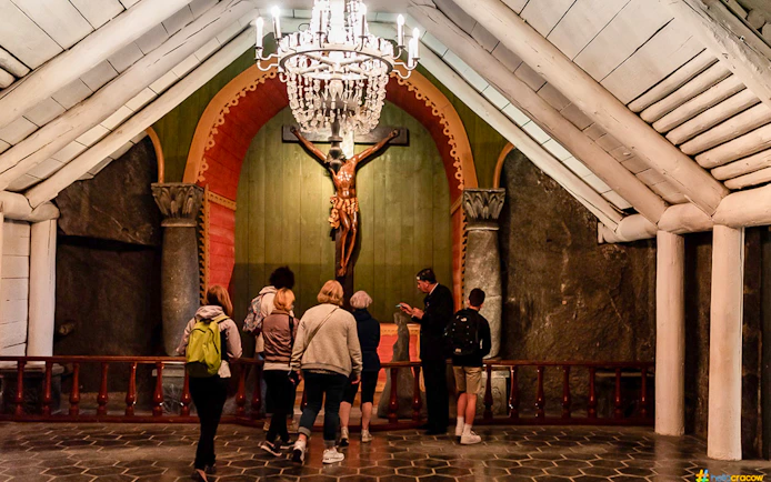 Guests touring Wieliczka Salt Mine chapel with guide.