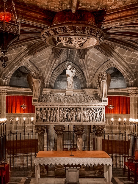Interior of the Cathedral of Barcelona with ornate altar and statues.