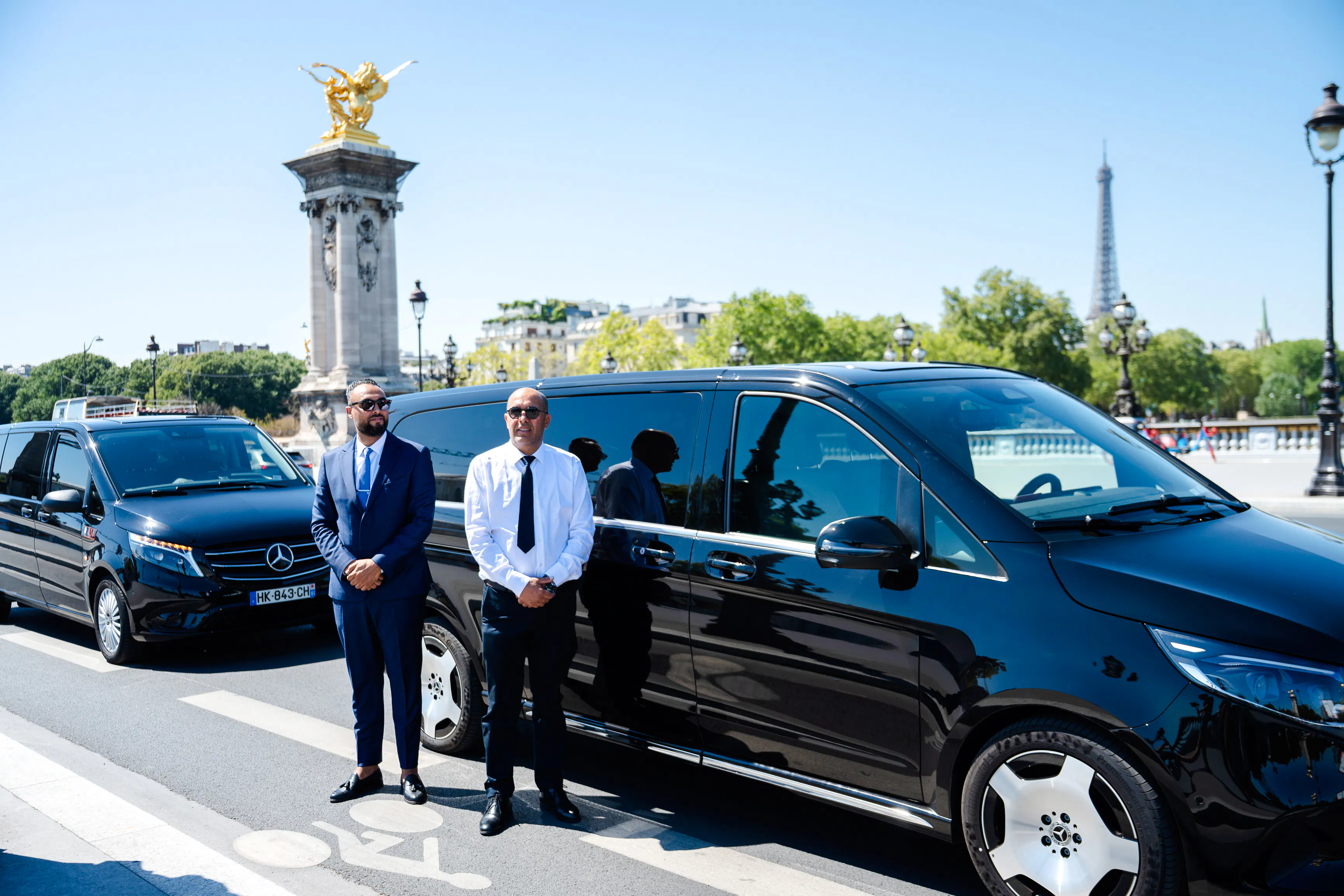 Private chauffeur with luxury van near Pont Alexandre III, Eiffel Tower in background, Paris tour.