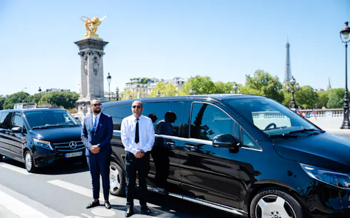 Private chauffeur with luxury van near Pont Alexandre III, Eiffel Tower in background, Paris tour.
