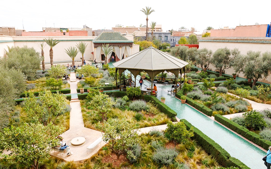 Jardin Secret in Marrakech, Morocco with lush gardens, pathways, and a central pavilion.