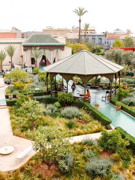 Jardin Secret in Marrakech, Morocco with lush gardens, pathways, and a central pavilion.
