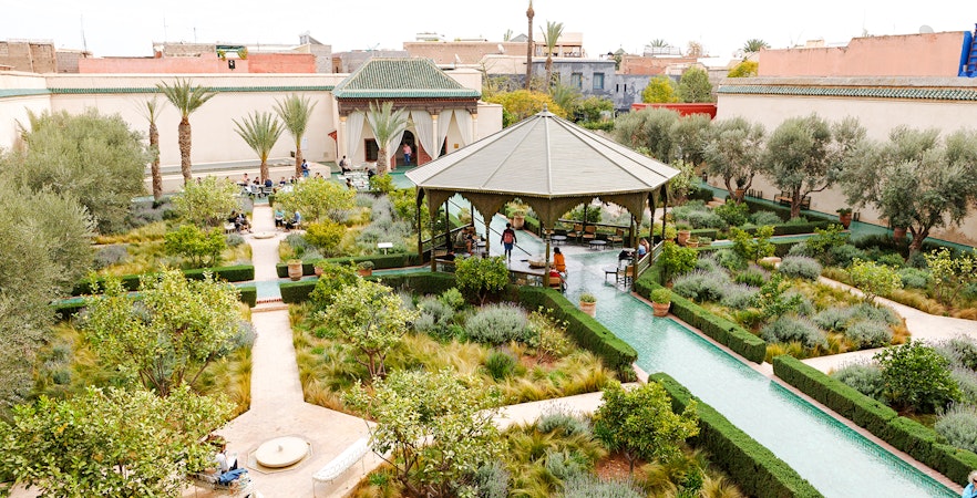 Jardin Secret in Marrakech, Morocco with lush gardens, pathways, and a central pavilion.