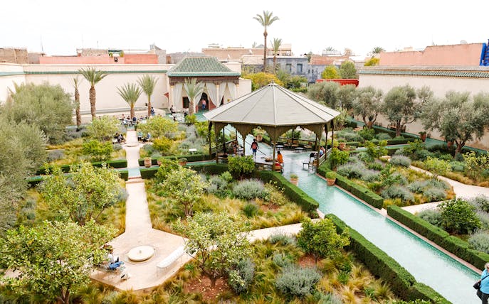 Jardin Secret in Marrakech, Morocco with lush gardens, pathways, and a central pavilion.