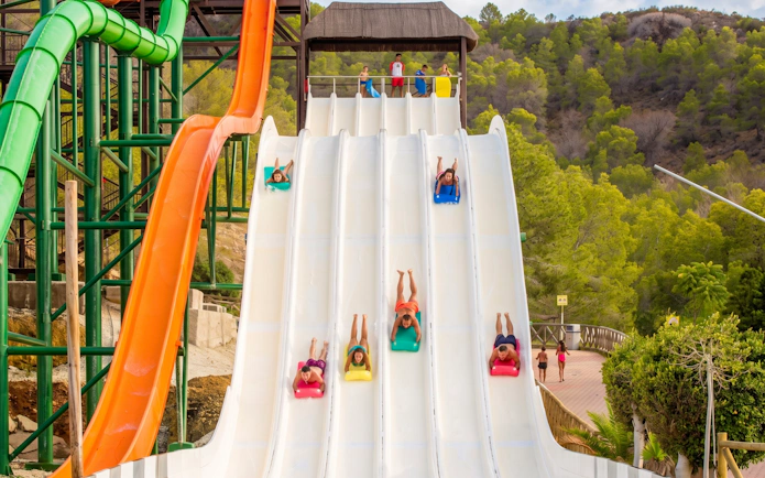 Visitors sliding down splash slide at Aqualandia Benidorm, Spain.
