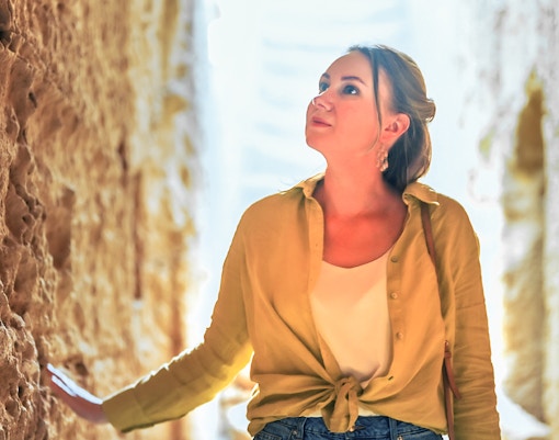 woman observing archaeological site