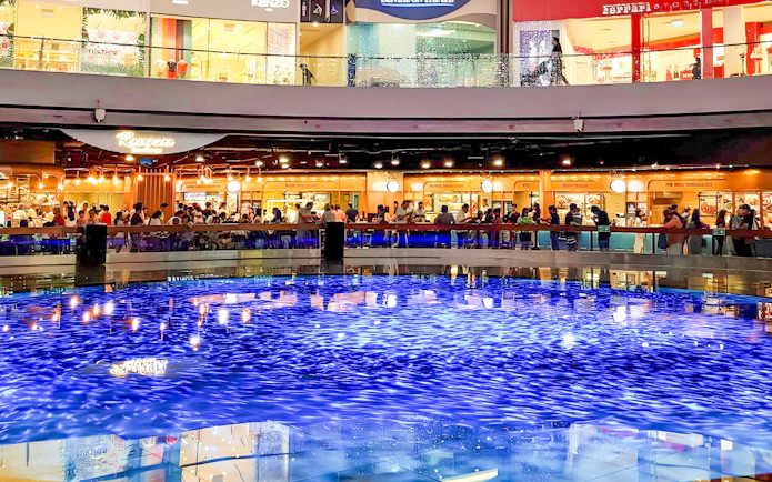Indoor canal at Marina Bay Sands with people watching Sampan Rides.