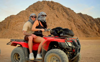 Couple riding a quad bike in the Sinai Desert, Sharm El Sheikh.