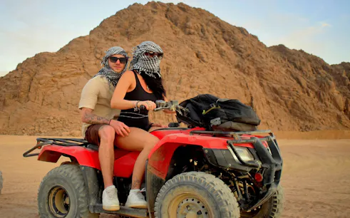 Couple riding a quad bike in the Sinai Desert, Sharm El Sheikh.