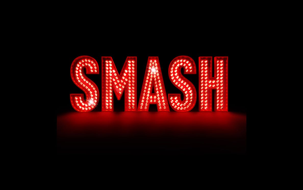 Illuminated red marquee letters spelling "SMASH" against a dark background.