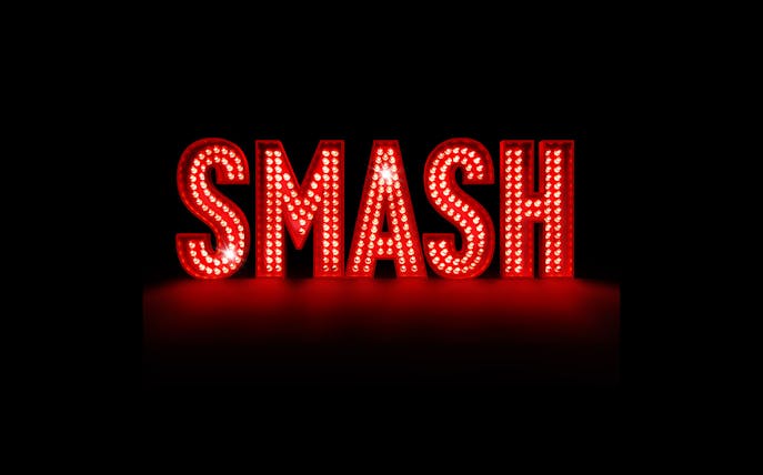 Illuminated red marquee letters spelling "SMASH" against a dark background.