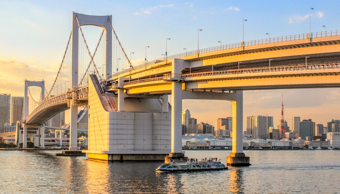 Cruise boat on Tokyo Bay with Rainbow Bridge in the background.