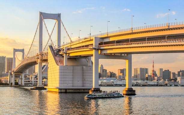Cruise boat on Tokyo Bay with Rainbow Bridge in the background.