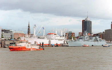 Hamburg harbor with ships and St. Michael's Church during 2-hour boat tour.