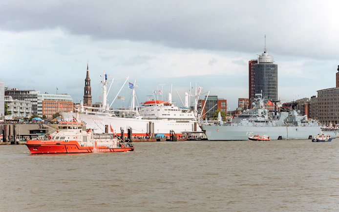 Hamburg harbor with ships and St. Michael's Church during 2-hour boat tour.