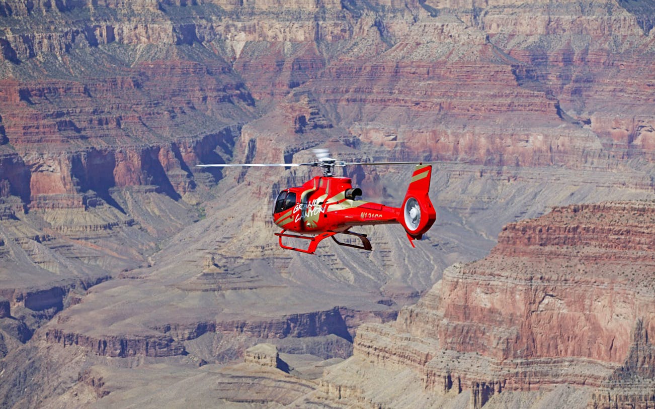 Helicopter flying over the Grand Canyon during the Grand Kingdom with Hummer Tour.