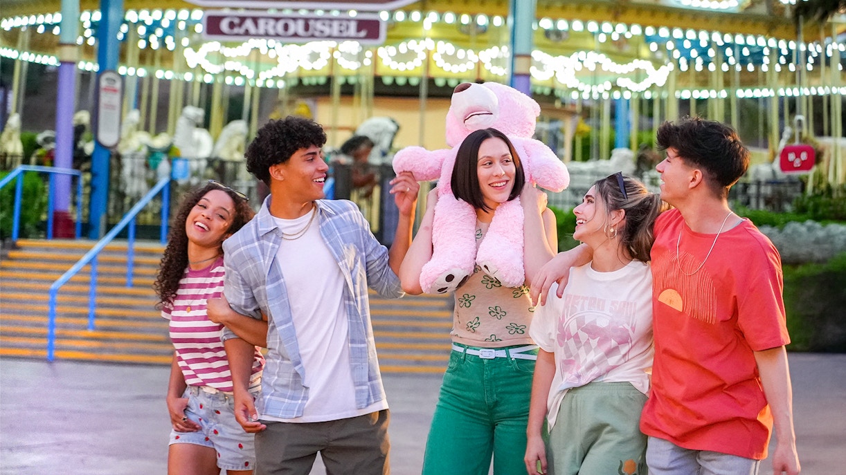 Friends enjoying the Grand American Carousel at Six Flags Magic Mountain.