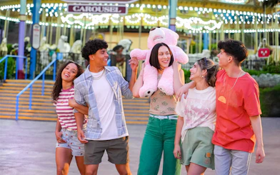 Friends enjoying the Grand American Carousel at Six Flags Magic Mountain.