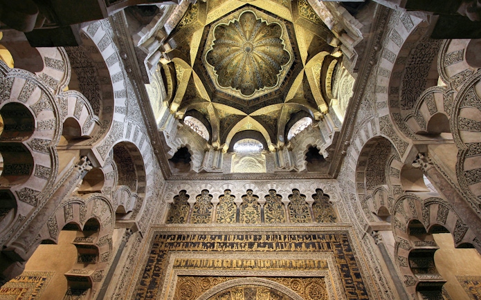 Cordoba Mosque-Cathedral Mihrab ceiling with intricate arches and detailed carvings.