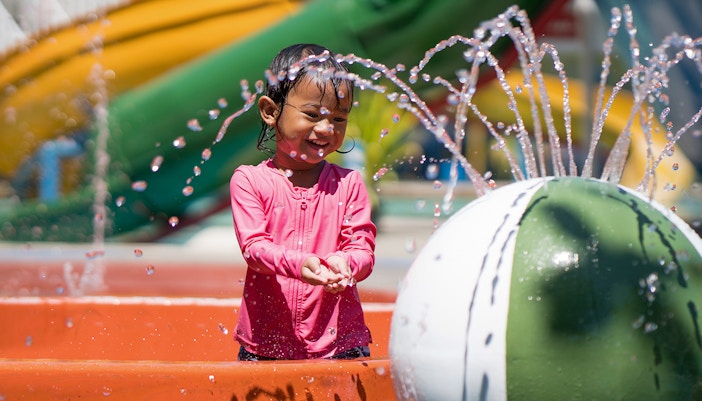 Child playing in water at a waterpark