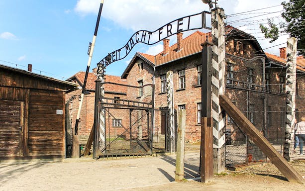 Entrance gate with "arbeit macht frei" at Auschwitz concentration camp, Poland.