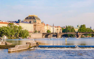 Prague's National Theatre and Vltava River during a sightseeing cruise.