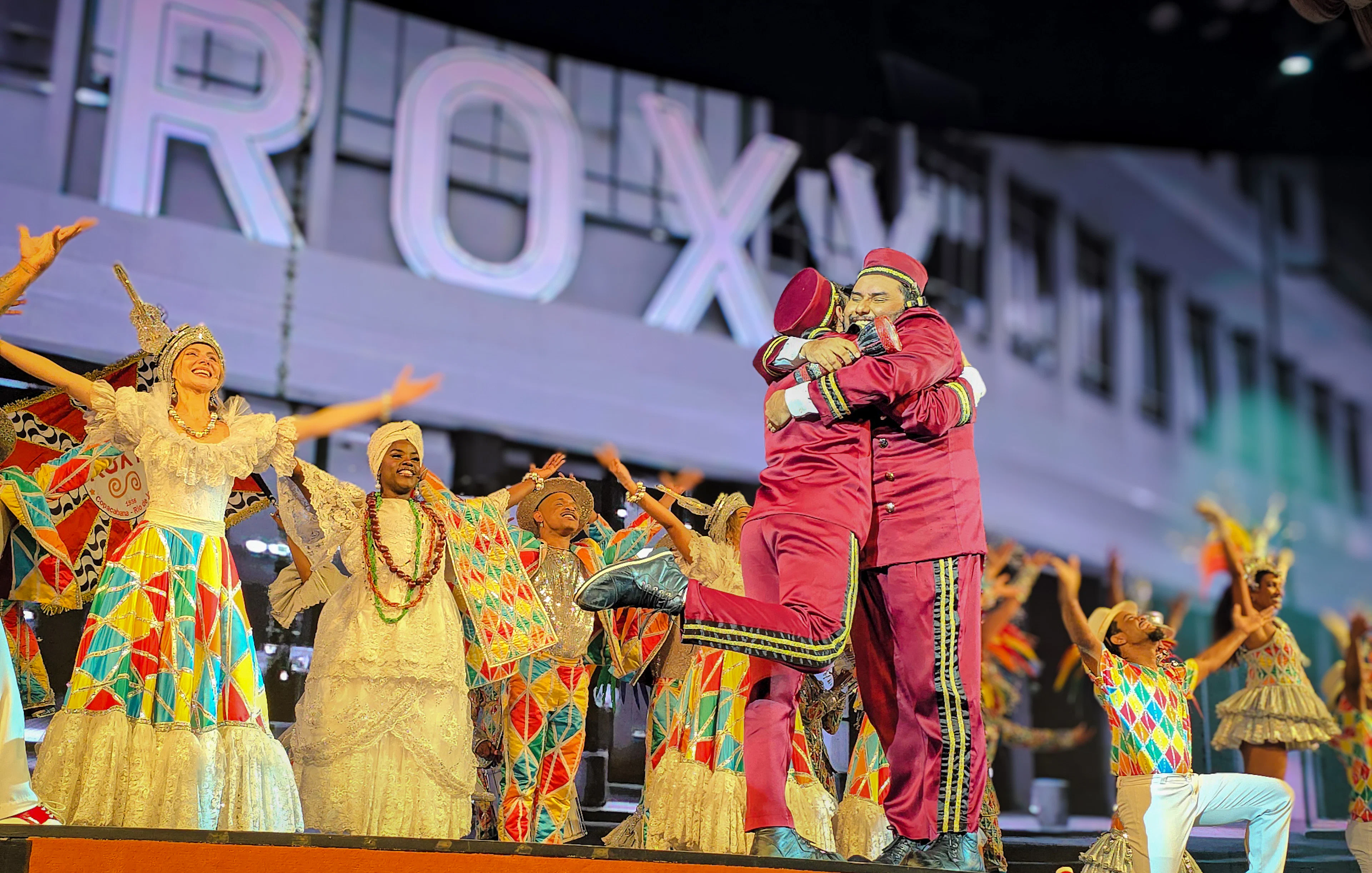Performers in vibrant costumes on stage at Roxy Dinner Show, Rio de Janeiro.