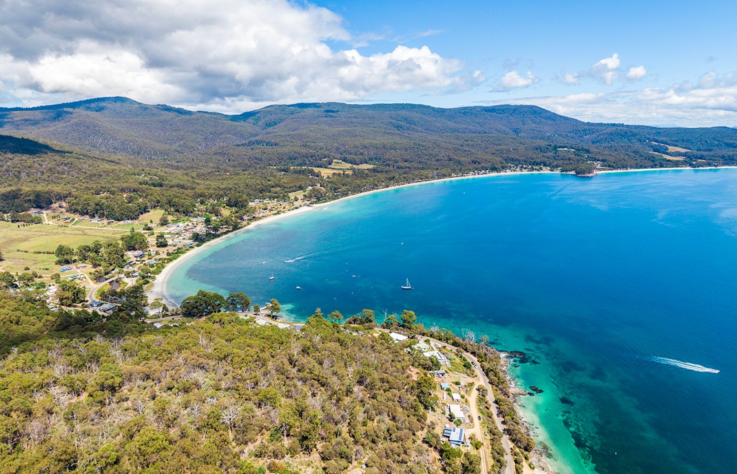 Bruny Island coastline view with tour group enjoying gourmet food experience.