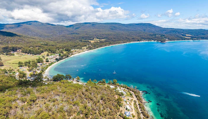 Bruny Island coastline view with tour group enjoying gourmet food experience.