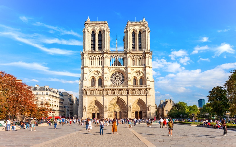 Notre Dame de Paris facade with tourists in the foreground, Paris, France.