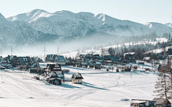 Snow-covered Zakopane village with Tatra Mountains backdrop on Krakow day trip.