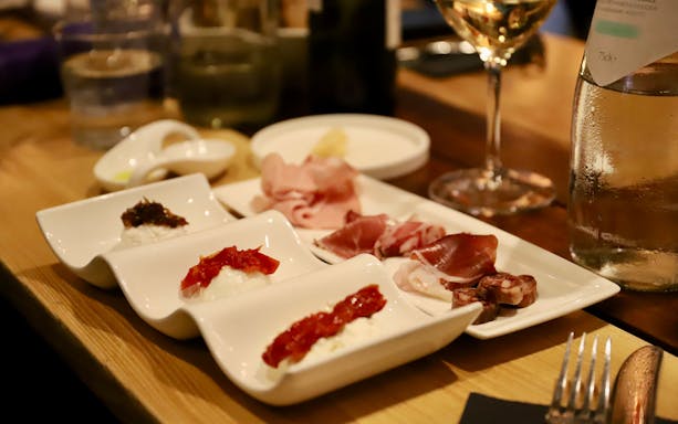 Italian antipasti platter with cured meats and cheeses on a morning food tour in Rome.