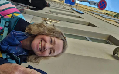 Person smiling during Nice Murder Mystery city exploration game in Nice, France.