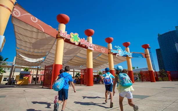 Children approaching Isla Mágica entrance in Seville.