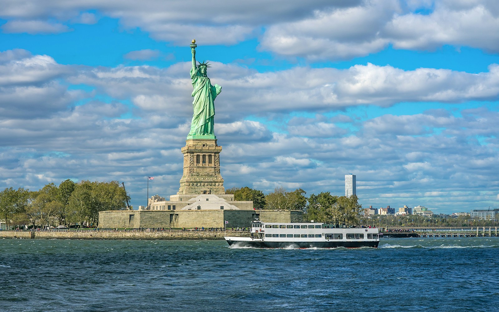 Statue of Liberty viewed from a cruise, New York City tour, Empire State Building access included.