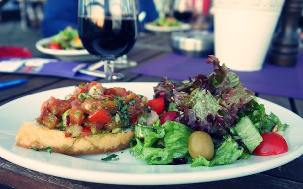 Bruschetta and salad served on a plate during HafenCity food tour.