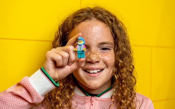 Child holding a LEGO figure at LEGO Discovery Centre Hamburg.