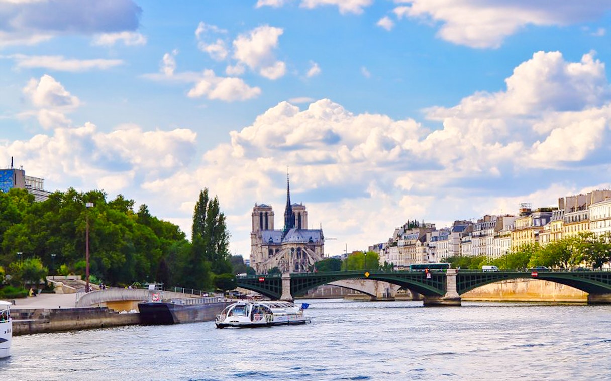 Seine River cruise with view of Notre-Dame Cathedral and Parisian architecture.