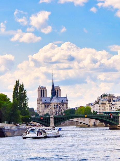 Seine River cruise with view of Notre-Dame Cathedral and Parisian architecture.