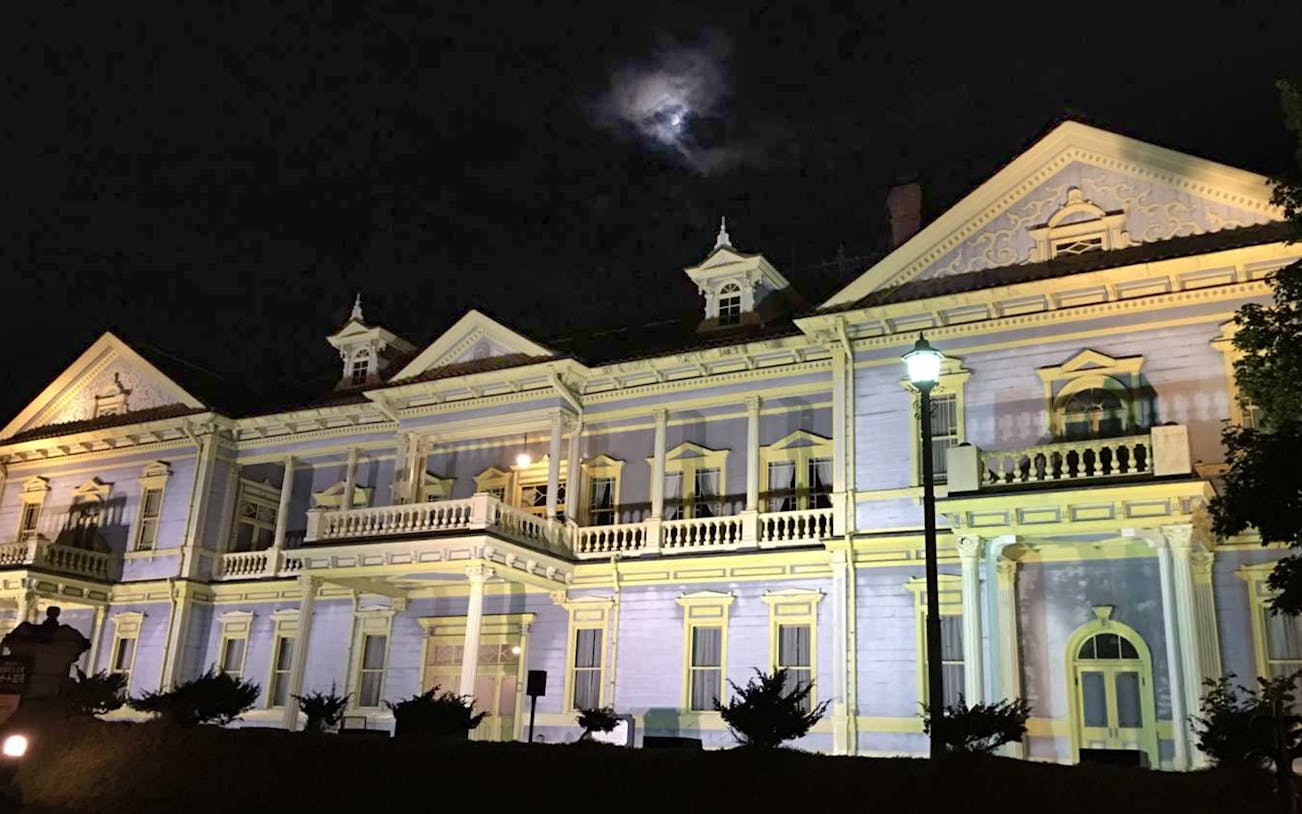Historic building illuminated at night on Mt. Hakodate Night View Course, Japan.