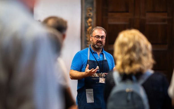 Tour guide speaking to tourists at Monastery of São Bento da Vitória.
