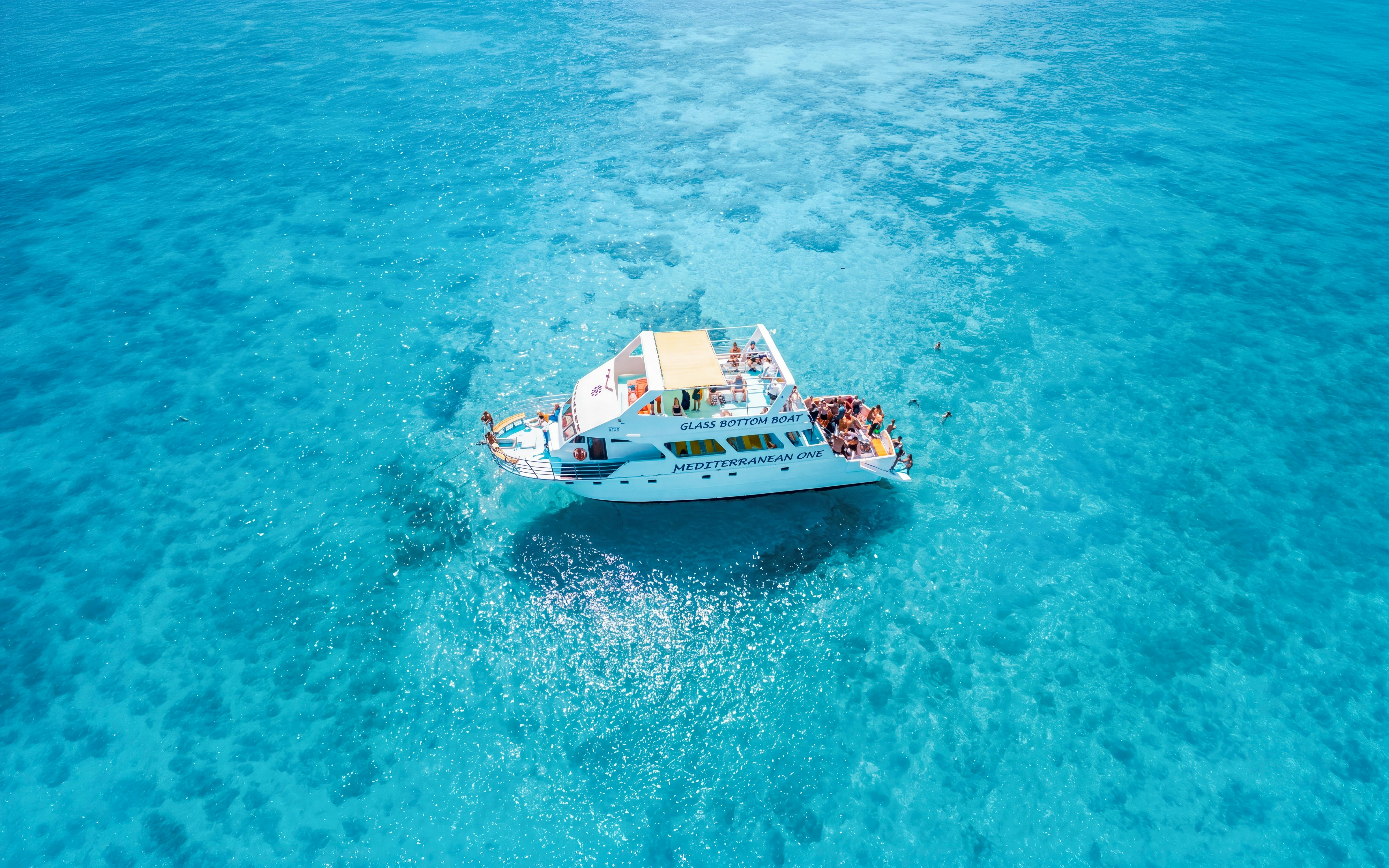 Glass-bottom boat Mediterranean One cruising in clear blue waters near Latchi.